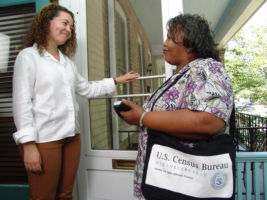U.S. Census Enumerator surveying neighborhood
