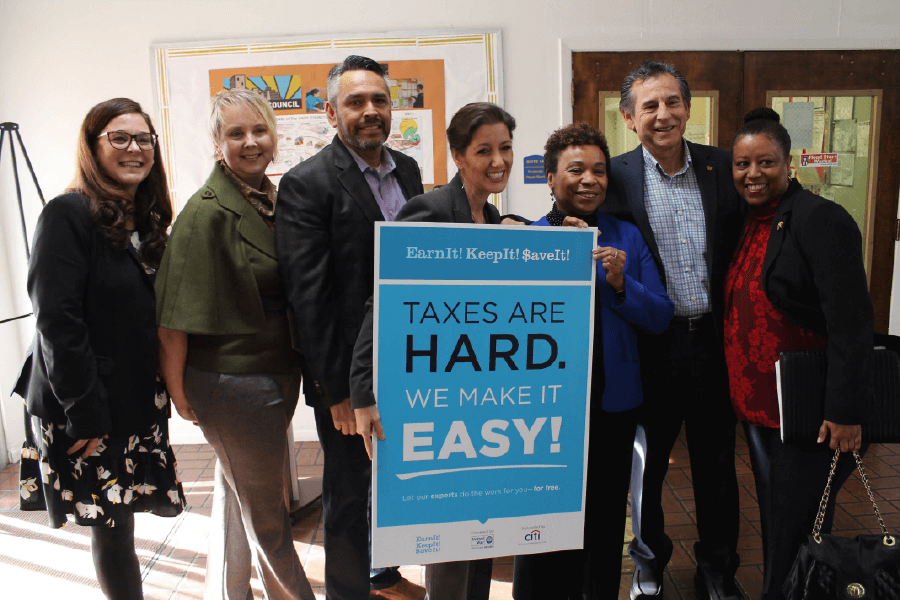 Group of City of Oakland officials and mayor Libby Schaaf holding EITC sign that reads Earn it, Keep it , Save it