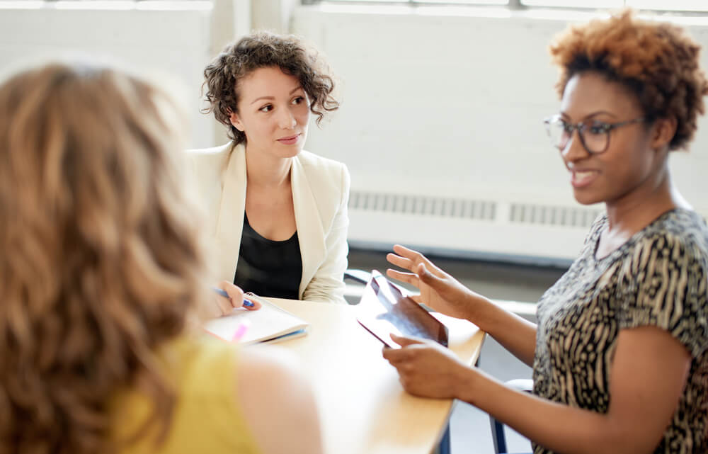 group of women talking at conference room